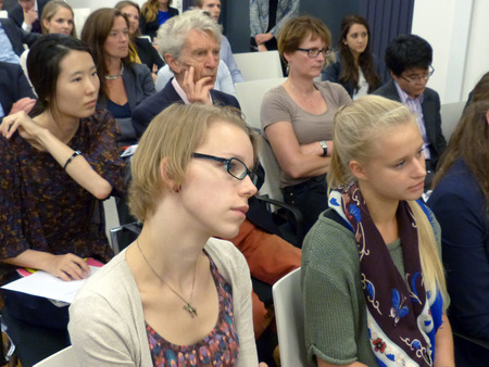 The audience listens attentively